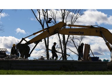 Workers clear out a house with only the foundation remaining in the Dunrobin area near Ottawa due to the damage caused by the tornado, October 12, 2018.