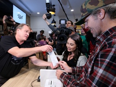 The co-holders of first place in line - Nikki Rose and Ian Power - became the first people to legally buy pot in Canada at midnight. Bruce Linton (left), founder, CEO and Chairman of Canopy Growth, travels from Ottawa to St. John's, Newfoundland on the eve of legalization of pot in Canada to sell the first gram of legal pot from his Tweed store in St. Johns at the stroke of midnight - long before it becomes legal in all the other provinces.