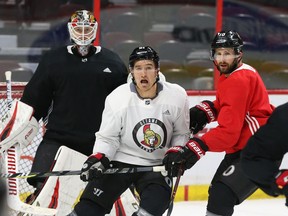 Mark Stone, centre, of the Ottawa Senators battles against Tom Pyatt in front of goalie Mike Condon during practice at the Canadian Tire Centre on Thursday, Oct. 18, 2018.