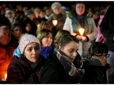 Some of Émilie Maheu's family members (front) couldn't contain their tears as people talked about the young woman at a vigil held in her memory on Wednesday evening, Oct. 24, 2018 in Alexandria.