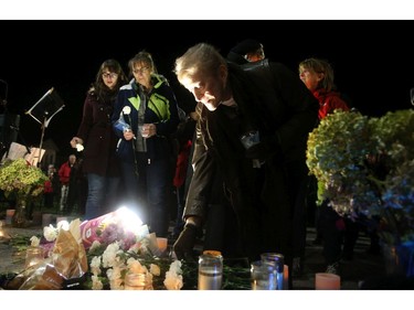 While family looks on (left), hundreds of people lay white carnations at a vigil held in the memory of  Émilie Maheu on Wednesday evening (Oct. 24, 2018) in Alexandria.