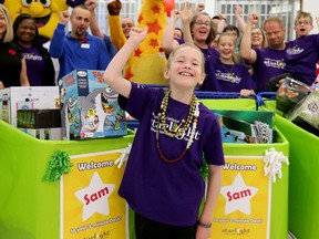 With his family (rear right - including dad, Wes Smiderle, mom, Amanda Robertson, sister Gwendolyn, 11, and little brother Griffin, 5), Sam Smiderle took off like a rocket for his 3-Minute Dash shopping spree at Toys "R" Us Monday at the St. Laurent Shopping Centre.