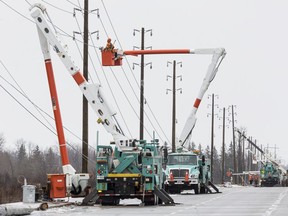 In this file art, Hydro Ottawa crews repair power lines along Limebank Road.