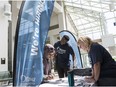 City of Ottawa election specialists' Christine Hanson (R) and Lionel Minkutu assist Sabah Haibeh (L) with her paperwork necessary to work during the municipal election. June 26, 2018. Errol McGihon/Postmedia