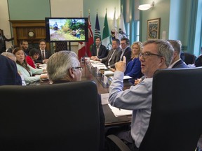 Mayor Jim Watson, right, chairs a meeting of community organizations supporting After the Storm relief efforts. October 3, 2018. Errol McGihon/Postmedia