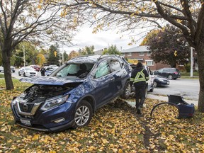 A tow truck operator prepares to remove a vehicle that ended up on the front lawn of a house on Woodroffe Avenue near Iris Street. October 12, 2018. Errol McGihon/Postmedia