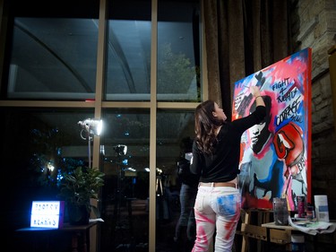 Painter Stefanie Kearns works on a piece during the event. Muhammad Ali, an acrylic on canvas painting, sold for over $1,000 in a silent auction for the Canadian Cancer Society.