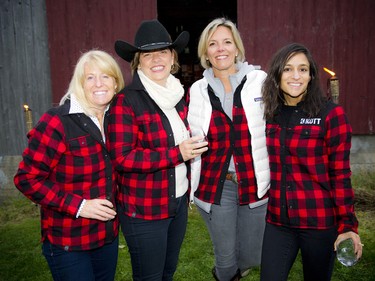 From left, Angela Taggart, Tracy Rait-Parkes, Melissa Kruyne and Angela Singhal, all wearing their barn chic Kott Lumber red plaid jackets.