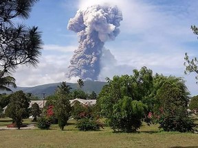 This handout picture taken and released on October 3, 2018 by Indonesia's National Agency for Disaster Management (BNPB) shows Soputan volcano erupting ash up to 4,000 metres above the crater, as seen from Pinabetengan in Southeast Minahasa, North Sulawesi Province. - The state disaster agency warned people to stay at least four kilometres away, but said there was no need to evacuate for the time being.