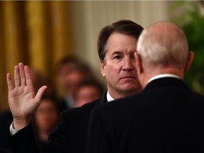 Brett Kavanaugh is sworn in as Associate Justice of the U.S. Supreme Court by Associate Justice Anthony Kennedy on Oct. 8, 2018 at the White House.