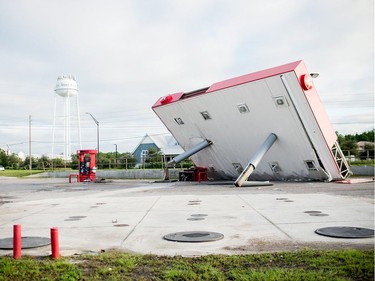 The overhang of a gas station is toppled over in the aftermath of Hurricane Michael on October 11, 2018 in  Inlet Beach, Florida. - Residents of the Florida Panhandle woke to scenes of devastation Thursday after Michael tore a path through the coastal region as a powerful hurricane that killed at least two people.