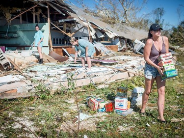 The Slaughter Family saves their merchandise from their antique store inside the collapsed 15th Street Flea Market on October 11, 2018 in Panama City, Florida. - Residents of the Florida Panhandle woke to scenes of devastation Thursday after Michael tore a path through the coastal region as a powerful hurricane that killed at least two people.