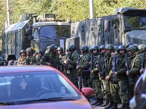 Special forces servicemen patrol a blast site at a college in the city of Kerch on October 17, 2018. - At least 18 people died in a blast in a technical college on the Crimean peninsula, with dozens more injured, Crimean head Sergei Aksyonov said on state television on October 17.