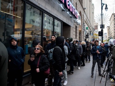 People line up outside a cannabis store to purchase products for the first time, October 17, 2018 in Montreal, Canada. -