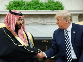 In this file photo taken on March 20, 2018 U.S. President Donald Trump (R) shakes hands with Saudi Arabia's Crown Prince Mohammed bin Salman in the Oval Office of the White House in Washington, DC.