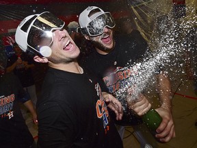 Houston Astros Alex Bregman, left, and Jake Marisnick celebrate after defeating the Cleveland Indians in Game 3 of the American League Division Series, Monday, Oct. 8, 2018, in Cleveland. (AP Photo/David Dermer)