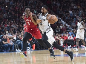 Toronto Raptors' OG Anunoby, left, defends against Brooklyn Nets' Spencer Dinwiddie during second half NBA pre-season basketball action in Montreal, Wednesday, October 10, 2018.