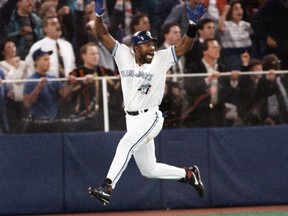 Joe Carter celebrates as he starts running the bases after hitting a three-run home run for the Blue Jays in Game 6 of the World Series against the Phillies on Oct. 23, 1993.