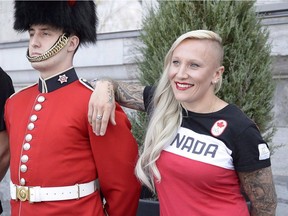 Kaillie Humphries poses with a member of the Governor General's Footguards following a celebration at Rideau Hall on May 9.