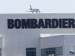 A 2015 file photo shows a plane coming in for a landing at a Bombardier plant in Montreal. THE CANADIAN PRESS/Ryan Remiorz