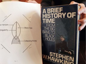 A book and scripts are among the personal and academic possessions of Stephen Hawking at the auction house Christies in London, Friday, Oct. 19, 2018.  The online auction announced Monday Oct. 22, 2018, by auctioneer Christie's will feature 22 items from Hawking, including his doctoral thesis on the origins of the universe, with the sale scheduled for Oct. 31-Nov. 8.