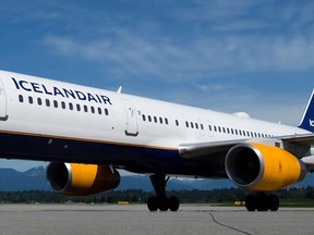 A tug decorated like a Viking ship tows an Icelandair Boeing 757 aircraft to a gate at Vancouver International Airport, during a photo opportunity to mark the airline's launch of flights between Vancouver and Reykjavik, in Richmond, B.C., on Wednesday May 14, 2014. THE CANADIAN PRESS/Darryl Dyck