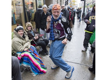 A man dances as he waits in line to purchase legal cannabis outside a government cannabis store in Montreal, Wednesday, October 17, 2018.