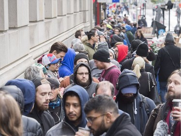People wait in line to purchase legal cannabis products outside a government cannabis store in Montreal, Wednesday, October 17, 2018.