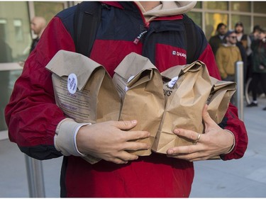 A customer carries his purchases as he leaves the Nova Scotia Liquor Corporation cannabis store in Halifax on Oct. 17, 2018. Residents can make their purchases at 12 Nova Scotia Liquor Corporation stores across the province and online.