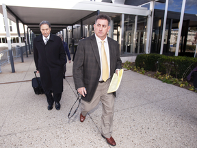 Former gymnastics coach Dave Brubaker, right, leaves the court house with his lawyer Patrick Ducharme in Sarnia, Ont., Oct. 23, 2018.