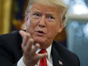 President Donald Trump speaks during an interview with The Associated Press in the Oval Office of the White House, Tuesday, Oct. 16, 2018, in Washington.