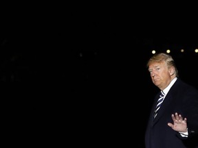 President Donald Trump waves as he walks across the South Lawn, Saturday, Oct. 20, 2018, returning to the White House in Washington after attending a rally in Nevada.