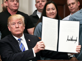 Surrounded by steel and aluminum workers — but not Leo Gerard — U.S. President Donald Trump signs off on contentious trade tariffs on March 8, 2018.