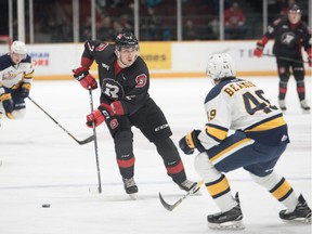 67's defenceman Noel Hoefenmayer (2) rushes the puck up the ice against the Otters' Luke Beamish during Sunday's game. Chris Hofley/OSEG.