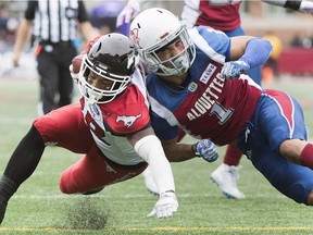 Calgary Stampeders' Terry Williams, left, evades a tackle from Montreal Alouettes' Branden Dozier to score a touchdown during second half CFL football action in Montreal, Monday, October 8, 2018.