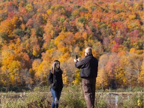 Essie Khossravi takes a photo of his daughter Nika, 14, as they take in the fall colours in Gatineau Park last Sunday.