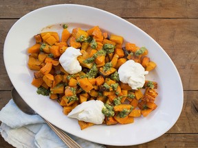 This November 2017 photo shows roasted squash with salsa verde and whipped feta and ricotta in New York. Making roasted squash is just a matter of cubing squash (which can easily be bought peeled and seeded), tossing it with some oil and salt, and letting it do its thing in the oven. (Lucy Beni via AP) ORG XMIT: NYLB201