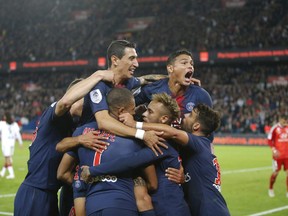 PSG's players celebrates after scoring their side's third goal during the French League One soccer match between Paris-Saint-Germain and Lyon at the Parc des Princes stadium in Paris, France, Sunday, Oct. 7, 2018.