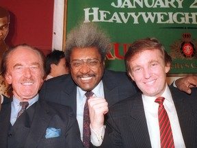 Donald Trump, right, is seen with his father, Fred Trump, left, and boxing promoter Don King in this December, 1987 photo.