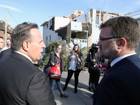 Quebec Premier Francois Legault along with Gatineau Mayor Maxime Pedneaud-Jobin survey the damage that was caused by a tornado last month in a Gatineau neighborhood, during a tour Friday, October 19, 2018.