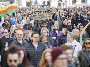 People attend a demonstration called "heart instead of hounding" to protest against a far right PEGIDA demonstration in Dresden, eastern Germany, Sunday, Oct.21, 2018.