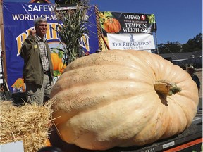 Steve Daletas of Pleasant Hill, Ore., celebrates his win in the 45th annual Safeway World Championship Pumpkin Weigh-Off in Half Moon Bay, Calif., on Monday. Aric Crabb/Bay Area News Group via AP