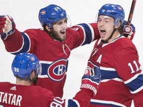 The Montreal Canadiens' Brendan Gallagher (11) celebrates with teammates Phillip Danault (24) and Tomas Tatar after scoring against the St. Louis Blues during the third period on Wednesday, Oct. 17, 2018.