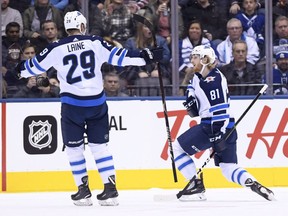 Winnipeg Jets left wing Kyle Connor (81)celebrates his goal against the Toronto Maple Leafs with teammate Patrik Laine (29) during first period NHL hockey action in Toronto on Saturday, October 27, 2018.