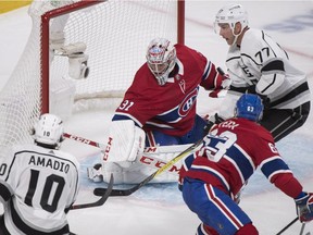 Montreal Canadiens goaltender Carey Price (31) is pressured by the Los Angeles Kings' Michael Amadio (10) and Jeff Carter (77).