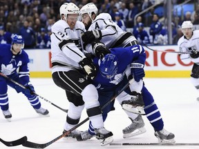 Los Angeles Kings defenceman Dion Phaneuf (3) and defenceman Drew Doughty (8) collide with Toronto Maple Leafs centre Zach Hyman (11) during second period NHL hockey action in Toronto on Monday, October 15, 2018.