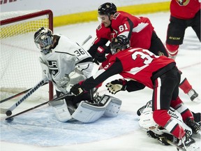 The Ottawa Senators' Mark Stone (61) and centre Colin White dive to push the puck across the goal line as Los Angeles Kings goaltender Jack Campbell (36) reacts during the first period on Saturday, Oct. 13, 2018. Stone was awarded the goal after review ruled the puck crossed the goal line.