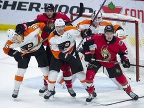 Players jostle for position in front of Philadelphia Flyers goaltender Calvin Pickard on Wednesday, Oct. 10, 2018 at the Canadian Tire Centre.