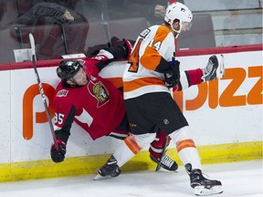 Philadelphia Flyers centre Sean Couturier sends Ottawa Senators centre Matt Duchene into the boards during first-period action on Wednesday, Oct. 10, 2018 at the Canadian Tire Centre.