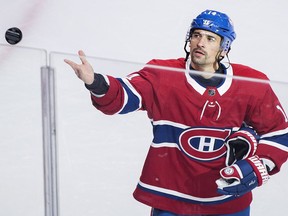 Montreal Canadiens' Tomas Plekanec throws a puck to fans following his 1000th NHL hockey game against the Detroit Red Wings in Montreal, Monday, October 15, 2018.